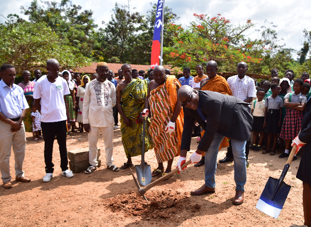 Chief Human Resources Director cutting sod for work to commence